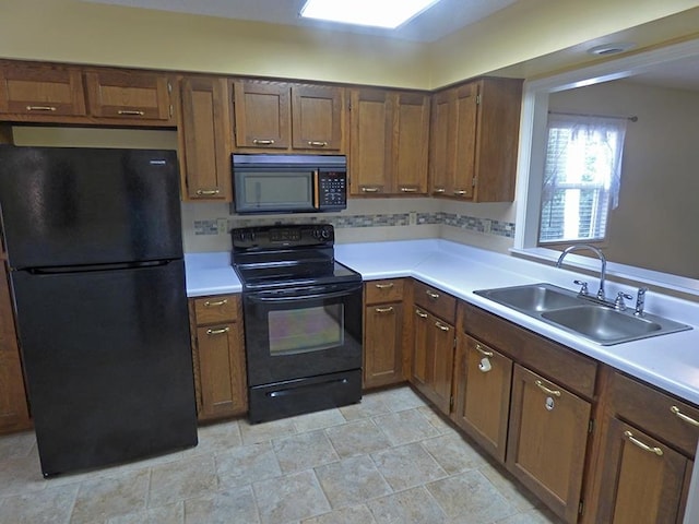 kitchen with black appliances and sink