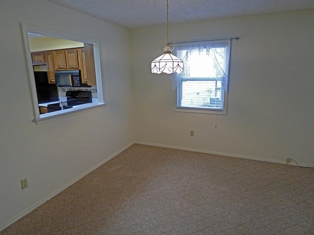 carpeted empty room with a textured ceiling