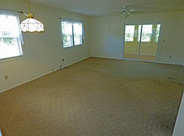 empty room with ceiling fan and carpet flooring