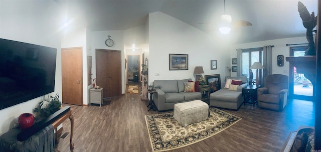 living room with high vaulted ceiling, ceiling fan, and dark wood-type flooring