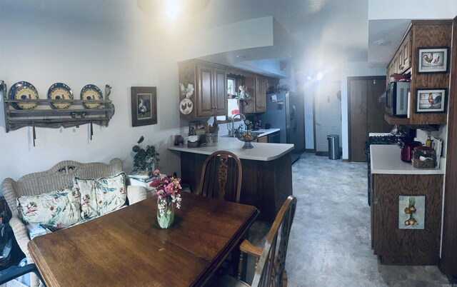 carpeted dining space featuring sink