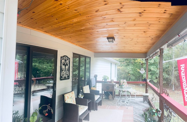 sunroom / solarium featuring wood ceiling