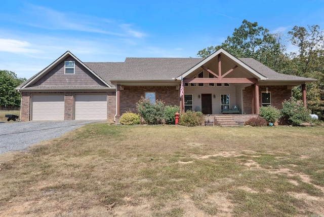 view of front of home featuring a garage, a porch, and a front lawn