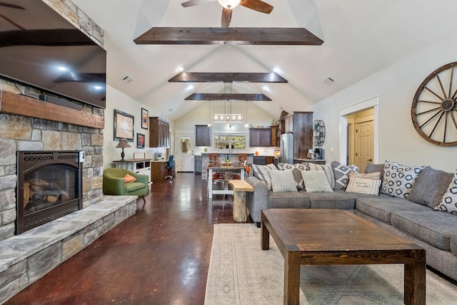 living room featuring ceiling fan with notable chandelier, lofted ceiling with beams, and a stone fireplace