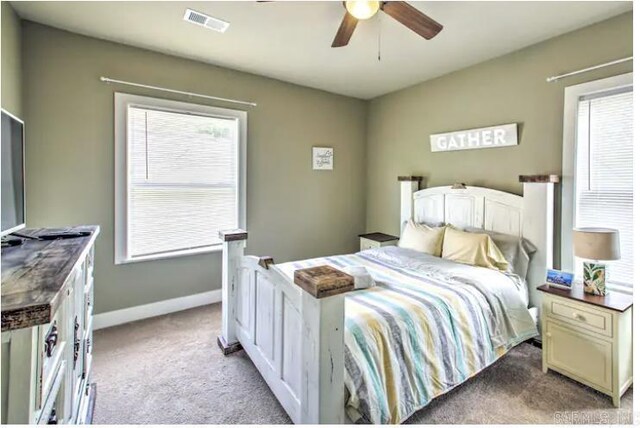 bedroom with light carpet and ceiling fan