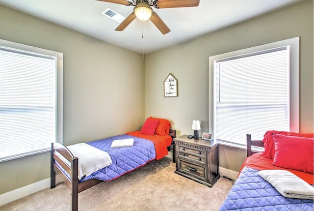 bedroom featuring visible vents, baseboards, carpet, and ceiling fan