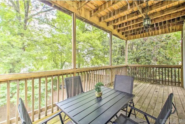 wooden terrace featuring outdoor dining area