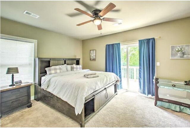 carpeted bedroom featuring access to exterior and ceiling fan