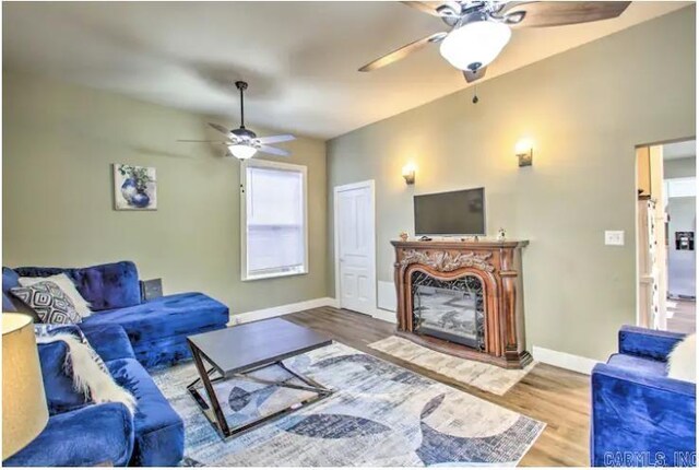 living room with hardwood / wood-style floors and ceiling fan