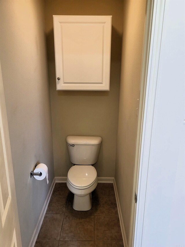 bathroom featuring toilet and tile patterned flooring