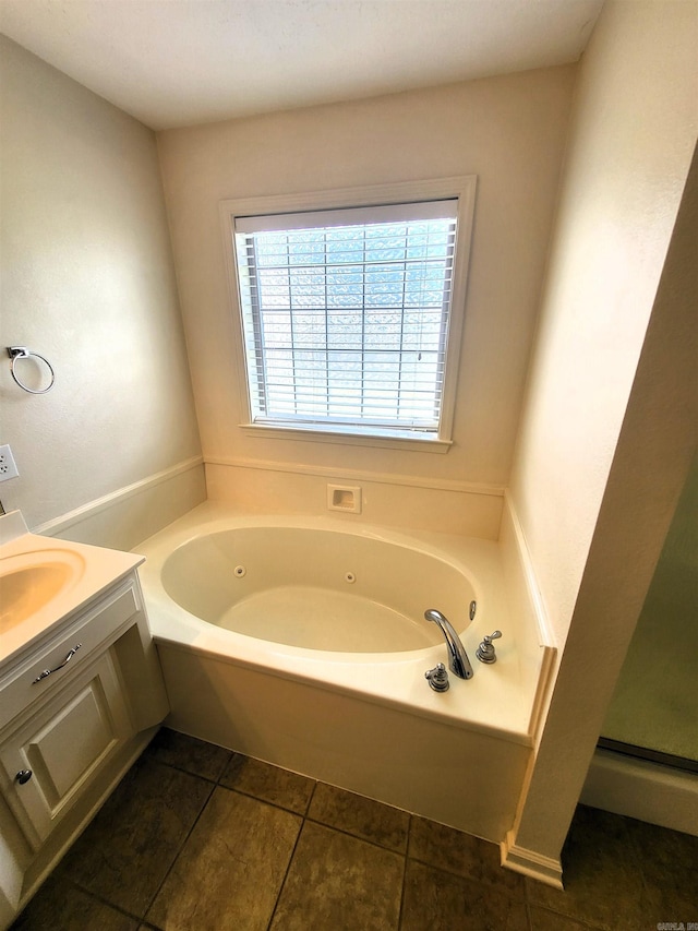 bathroom with tile patterned flooring, vanity, and shower with separate bathtub