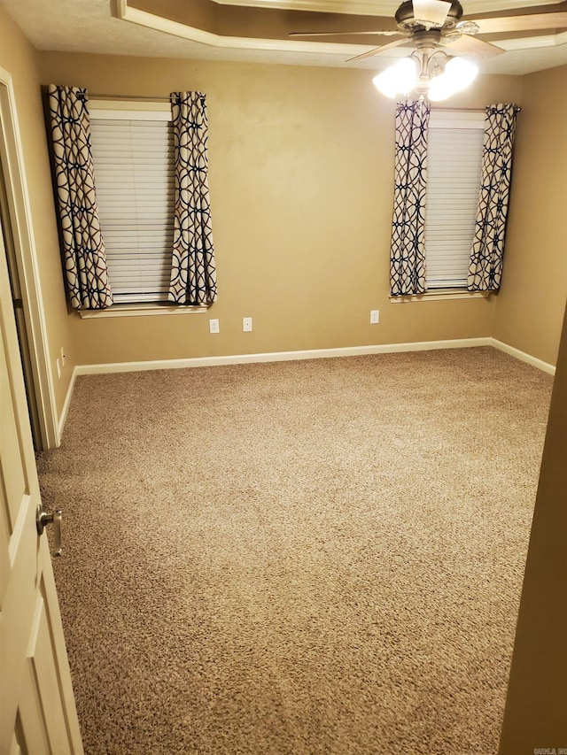 unfurnished room with ceiling fan and carpet