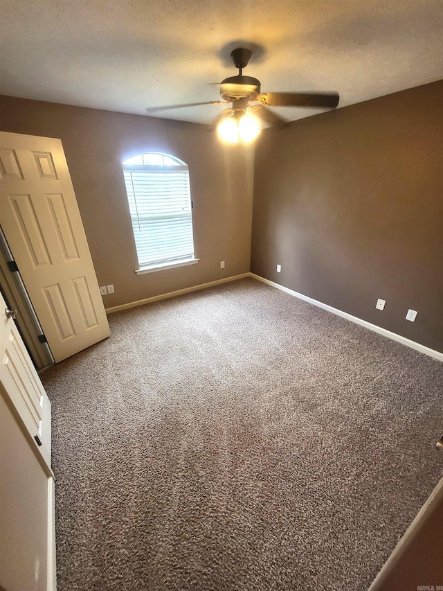 unfurnished room featuring carpet flooring, ceiling fan, and a textured ceiling