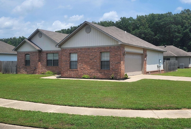 view of front of property with a garage, central AC, and a front yard