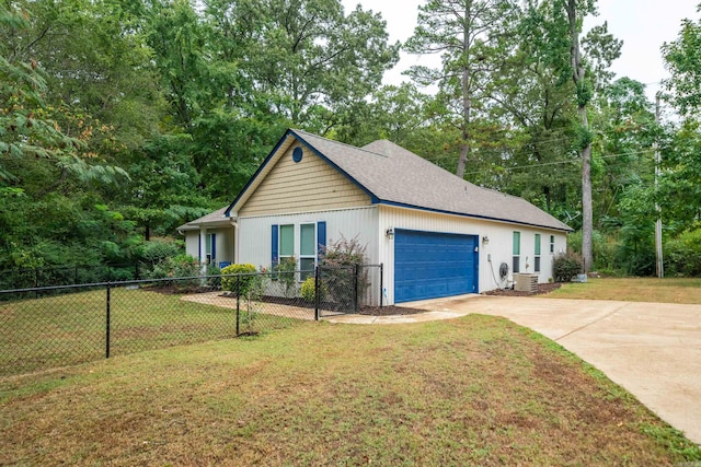 view of home's exterior with a lawn, a garage, and central AC unit