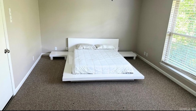 bedroom featuring dark carpet