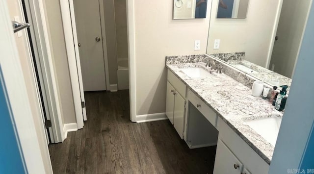 bathroom with vanity and hardwood / wood-style floors