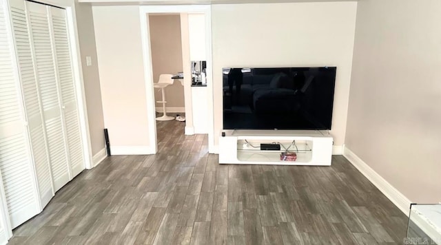 unfurnished living room with dark wood-type flooring