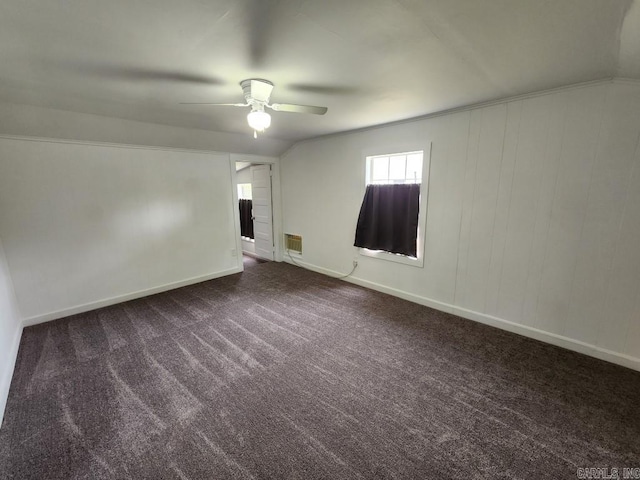 carpeted spare room with lofted ceiling and ceiling fan