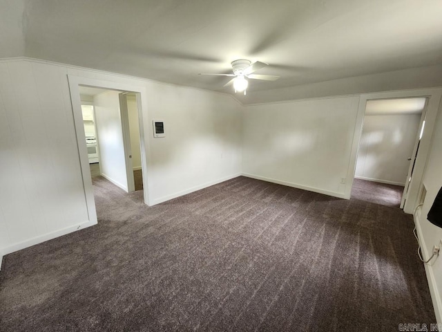 carpeted empty room featuring lofted ceiling and ceiling fan