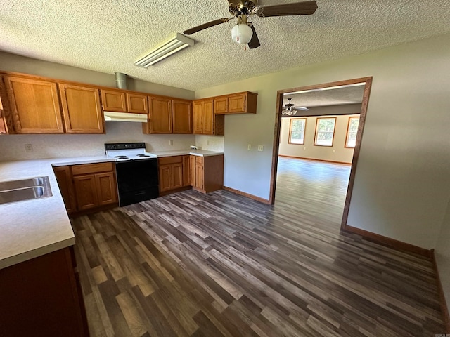 kitchen featuring dark hardwood / wood-style flooring, a textured ceiling, ceiling fan, sink, and white range with electric cooktop