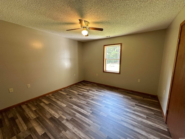 empty room with dark hardwood / wood-style flooring, a textured ceiling, and ceiling fan