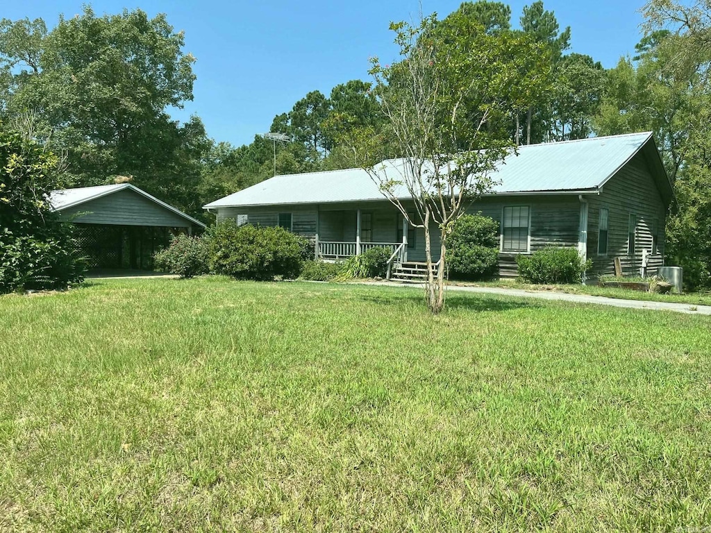 ranch-style home with a porch, a front lawn, and cooling unit