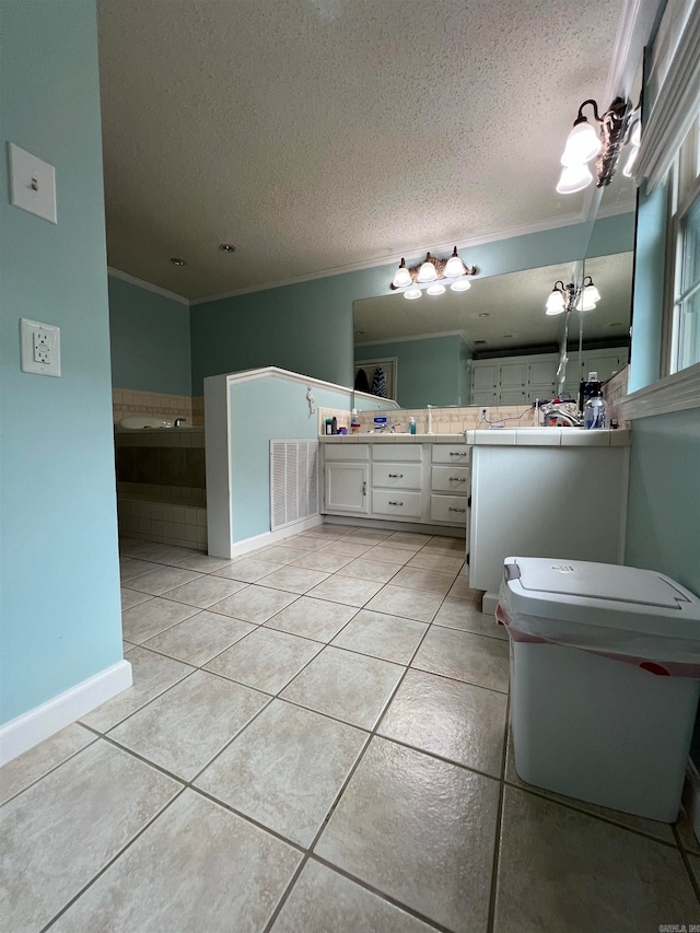 bathroom with a tub to relax in, vanity, a textured ceiling, crown molding, and tile patterned floors