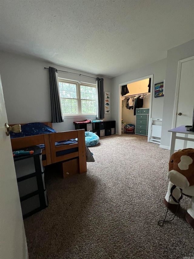 carpeted bedroom featuring a textured ceiling