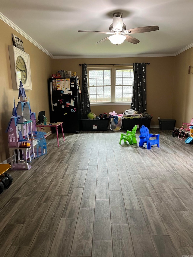 recreation room featuring crown molding, ceiling fan, and wood-type flooring