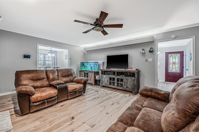 living room featuring crown molding, light hardwood / wood-style flooring, and ceiling fan