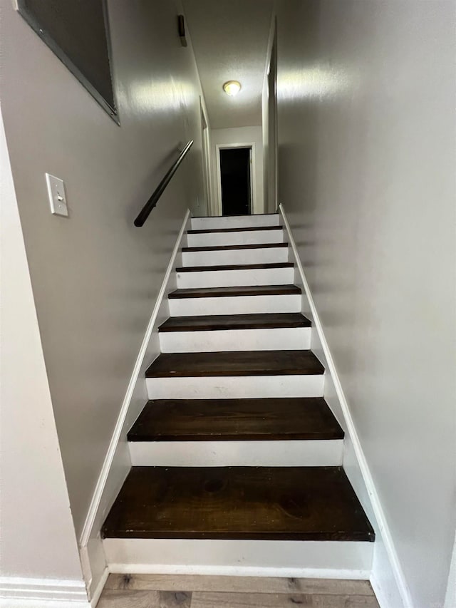 stairs featuring wood-type flooring