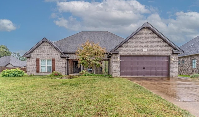 view of front facade with a front yard and a garage