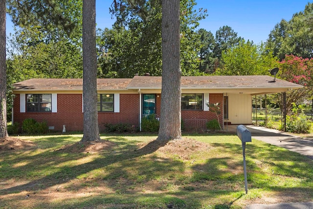 ranch-style house featuring a carport and a front yard