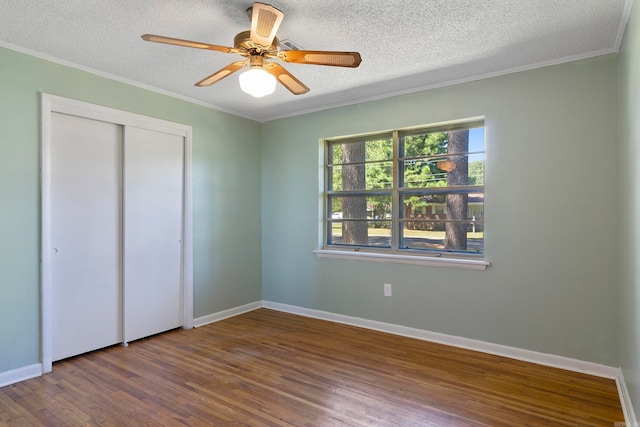 unfurnished bedroom with hardwood / wood-style floors, ceiling fan, and a textured ceiling