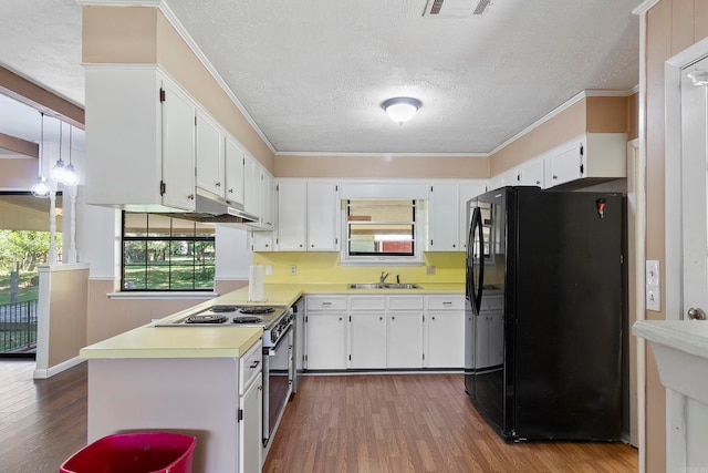 kitchen featuring decorative light fixtures, sink, dark wood-type flooring, white cabinets, and black fridge