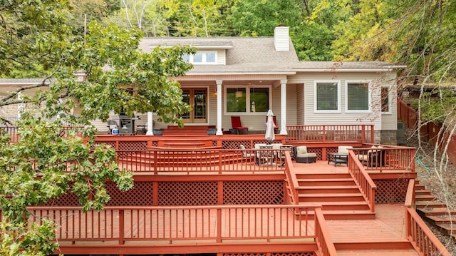 rear view of house featuring a wooden deck