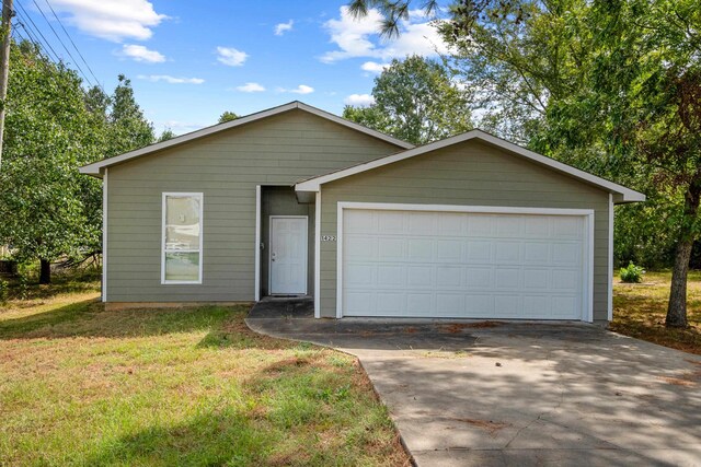 view of front of property with a garage and a front lawn