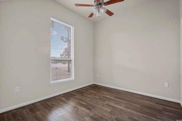 spare room with dark hardwood / wood-style flooring and ceiling fan