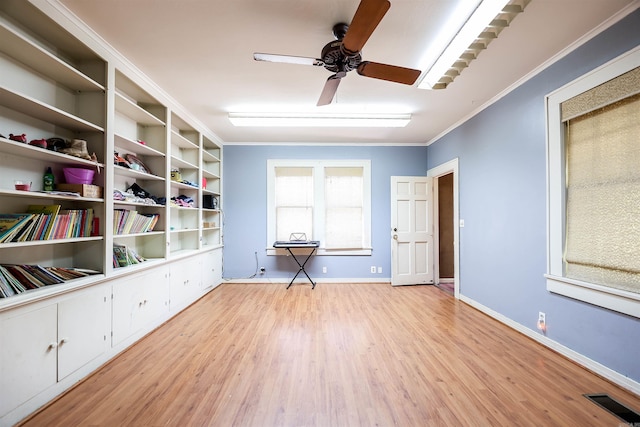 interior space featuring ceiling fan, ornamental molding, and light hardwood / wood-style flooring