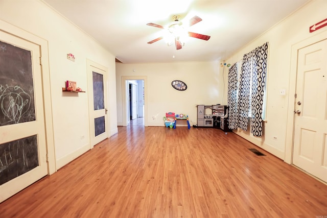 misc room with ceiling fan, hardwood / wood-style flooring, and crown molding