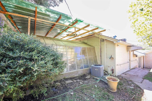 rear view of house with central AC unit