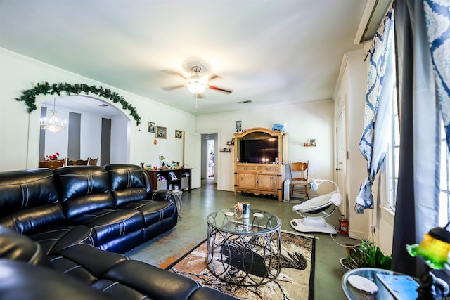 living room featuring ceiling fan with notable chandelier