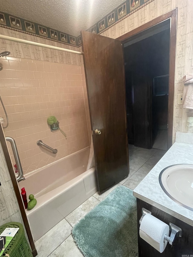 bathroom with shower / bathing tub combination, tile patterned flooring, vanity, and a textured ceiling