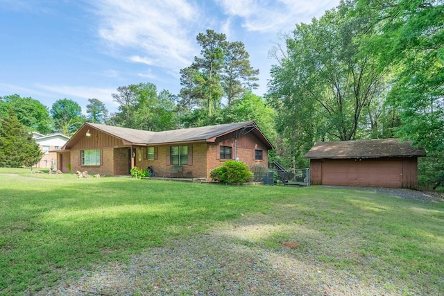 ranch-style house with a garage, an outdoor structure, and a front yard