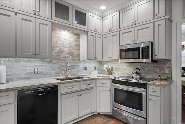 kitchen with appliances with stainless steel finishes, white cabinetry, and sink