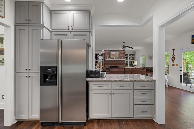 kitchen with a healthy amount of sunlight, dark hardwood / wood-style floors, and stainless steel fridge