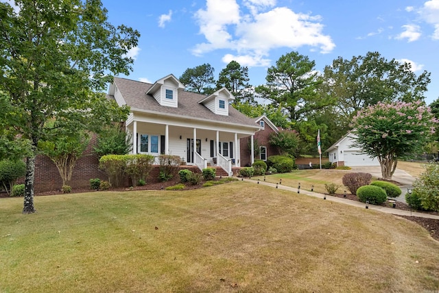 cape cod house with a garage, a front lawn, and covered porch