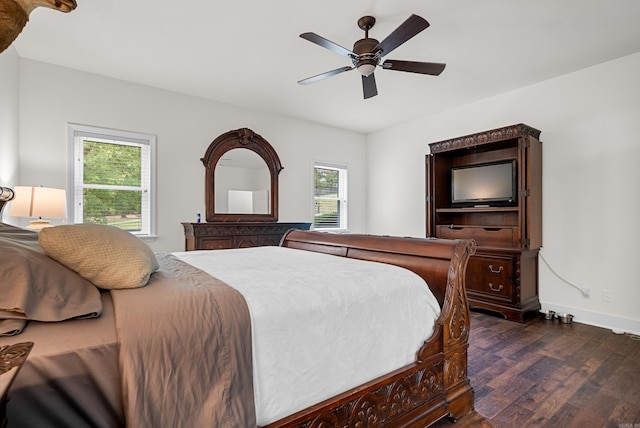 bedroom with dark wood-type flooring, multiple windows, and ceiling fan