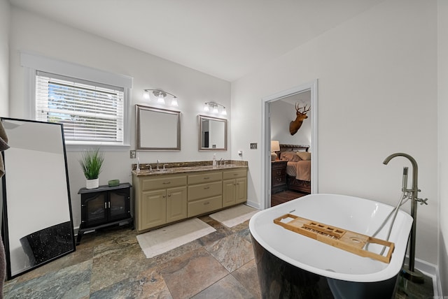 bathroom featuring vanity and a tub